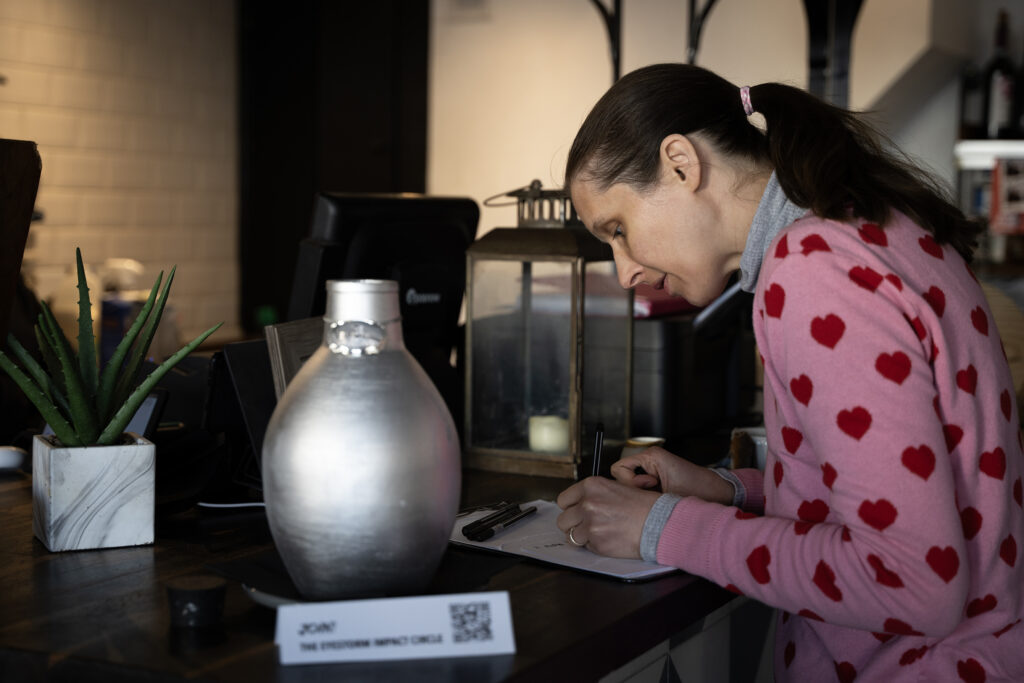 Alice Clover writing her impact pledge